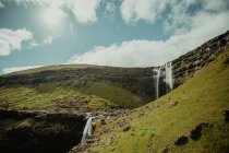 Scenic landscape of waterfall in green valley — Stock Photo