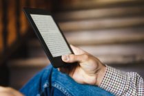 Crop male hand with electronic book tablet — Stock Photo