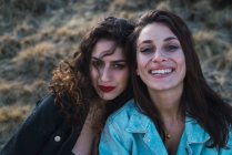 Portrait of two brunette girls looking at camera — Stock Photo
