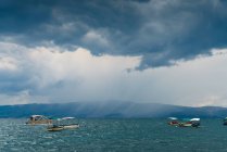Marine with floating boats under cloudy sky — Stock Photo