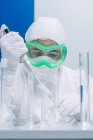 Scientist using pipette while experiment — Stock Photo