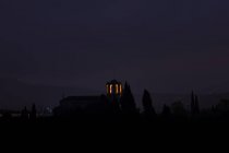Distant view of lit bell tower at night — Stock Photo