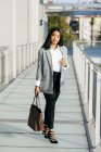 Elegant businesswoman in jacket posing on balcony passage — Stock Photo
