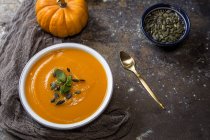 Still life of homemade cream of pumpkin in bowl on stone surface — Stock Photo