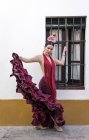 Фламенко, танцівниця носіння типовий костюм проведення в руці, спідниця і дивлячись на камеру — стокове фото