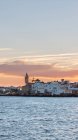 Distant view of coast town building at sunset — Stock Photo