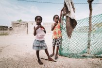 Goree, senegal- 6. Dezember 2017: kleine schwarze Mädchen stehen zusammen auf der Straße. — Stockfoto