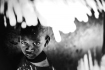 Goree, Senegal- December 6, 2017: Low angle portrait of little black boy looking at camera — Stock Photo