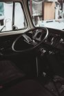 Black steering wheel in interior of retro van in good condition. — Stock Photo