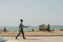 Goree, Senegal- December 6, 2017:Black people spending time on coastline of ocean in poor city. — Stock Photo