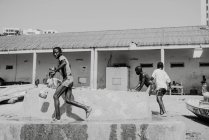 Goree, Senegal- 6 dicembre 2017: Bambini che giocano per strada e si annaffiano a vicenda . — Foto stock
