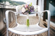 Beautiful bouquet placed on chair at terace — Stock Photo