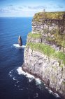Sunlit Moher cliffs on Atlantic rocky coast on summer day — Stock Photo