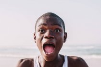 Yoff, Senegal - December 6, 2017: Portrait of expressive teenager looking at camera with great astonishment . — стоковое фото