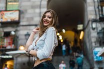 Low angle portrait of brunette woman posing at street — Stock Photo