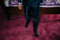 Low section of man wearing trendy suit and shiny formal footwear. — Stock Photo