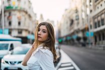 Élégante fille brune posant dans la rue — Photo de stock