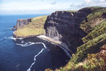 Sunlit cliffs of Moher on Atlantic countryside coastline — Stock Photo