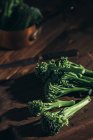 Close up view of fresh bimi broccoli stems on wooden table. — Stock Photo