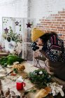 Side view of woman taking photo of flower composition on table at flower shop — Stock Photo