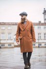 Portrait of vintage dressed bearded man walking in city — Stock Photo