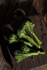 Directly from above view of fresh bimi broccoli vegetables on wooden board. — Stock Photo