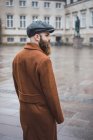 Rear view of stylish bearded man at square — Stock Photo