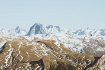 Panoramic view to snow covered mountains in sunlight — Stock Photo