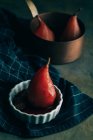 Low angle view of poached pears served in ceramic bowl — Stock Photo