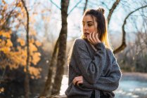 Side view of dreamy woman posing in autumnal woods — Stock Photo