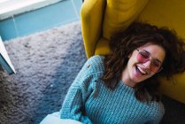 Directly above view of laughing woman sitting on floor — Stock Photo