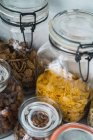Close up view of glass jars with assortment of snacks. — Stock Photo