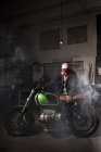 Mechaniker betätigt maßgeschneidertes Motorrad in Werkstatt — Stockfoto