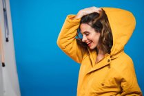 Side view of cheerful woman in yellow jacket — Stock Photo