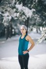 Young sportswoman posing in snowy woods. — Stock Photo