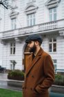 Portrait of bearded man wearing vintage clothes posing at street — Stock Photo