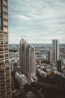 High skyscrapers towers on background of small buildings scape — Stock Photo