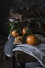 Still life of small Mandarin oranges with branches on  table. — Stock Photo