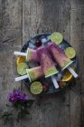 Directly above view of fruit Smoothie Popsicles in plate on wooden table — Stock Photo