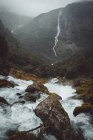 Rapid mountain river on background of foggy landscape — Stock Photo