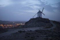 Vista para o moinho de vento histórico sob céu nublado no crepúsculo . — Fotografia de Stock