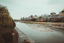 View to village houses and river in cloudy day. — Stock Photo