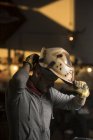 Professional welder putting on welder mask — Stock Photo