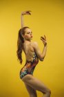 Вид збоку молода жінка танцює в студії з закритими очима — стокове фото