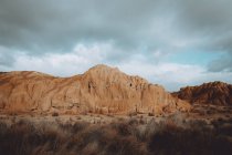 Prairie landscape with sandy cliffs under dramatic sky — Stock Photo