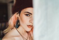 Obscured portrait of woman with pink hair at window — Stock Photo