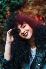 Portrait of cherfull curly woman in park — Stock Photo