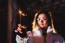 Woman holding sparkler in abandoned building — Stock Photo