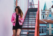 Young woman posing on stairs on street scene — Stock Photo