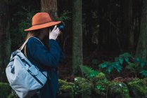 Вид збоку туристичних жінка з рюкзака зйомці в зелений ліс. — стокове фото
